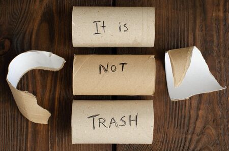 toilet paper cores on wooden background. Zero waste. Recycling. Top view.