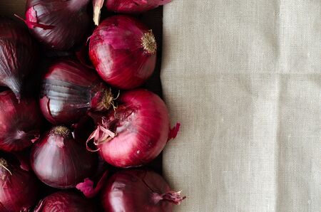 Bulb onion background with copy space. Agricultural background. Onions and red onions. Top viewの写真素材