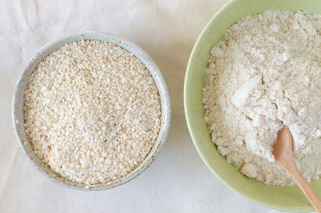 sesame flour and benne oilcake after oil making in bowls on linen background. Top view.の写真素材