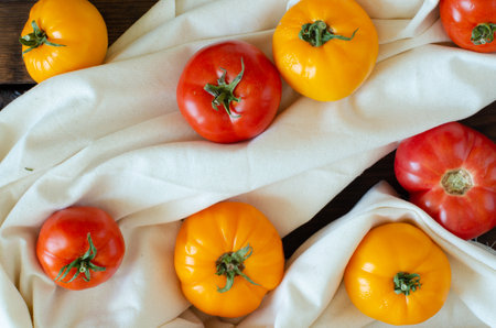 tomatoes on white linen on wooden background. Top view.の写真素材
