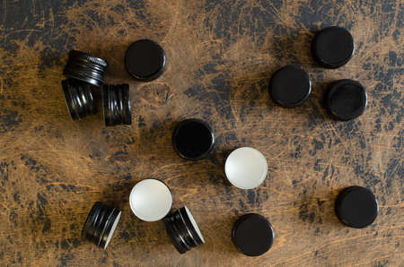 black bottle screw caps on abstract wooden background. Top view.の写真素材