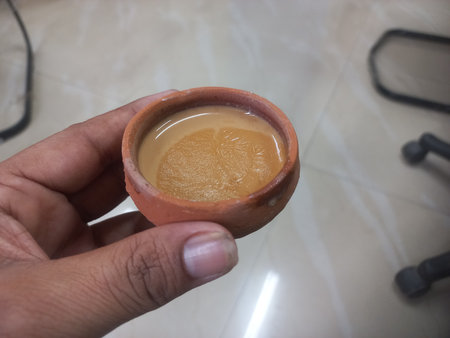 This photo shows a traditional kulhad (clay cup) filled with chai (Indian tea).These clay cups are commonly used to serve hot tea in India, especially at roadside tea shops. Kulhaの写真素材