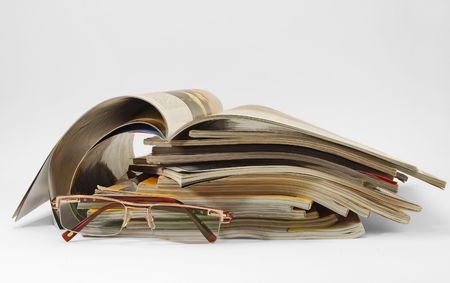 old magazines and glassesの写真素材