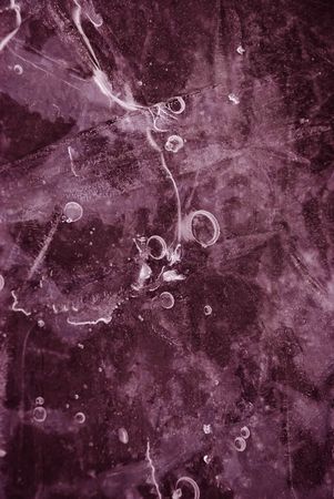 Close up: ice frozen water natural background. Dark magenta colouredの写真素材
