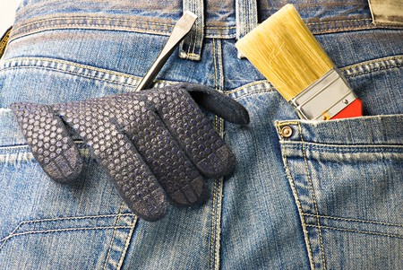 working tools in the back pocket of old used jeansの写真素材