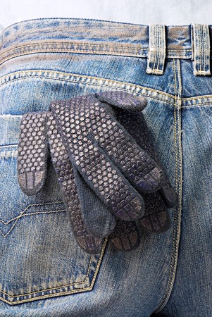 working glove in the back pocket of old used jeans