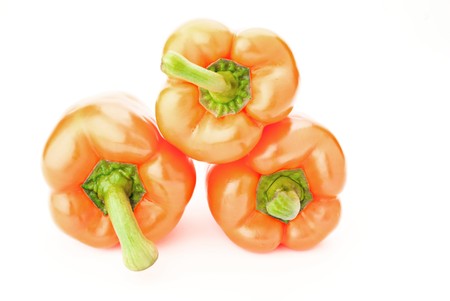three orange peppers over whiteの写真素材