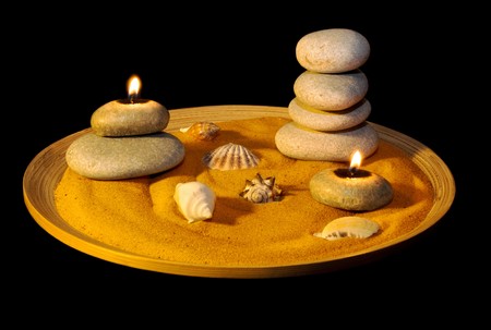 Summer evening background. Candles, seashells and pearls on sand. Gold tinted imageの写真素材