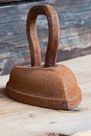 Old rusty iron over wooden backgroundの写真素材