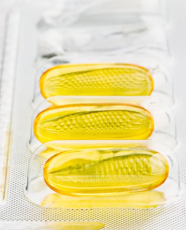 Macro of transparent pills of vitamin in half empty blister. Sallow depth of fieldの写真素材