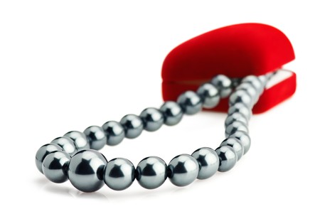 Red velvet gift box and black pearl necklace over white. Shallow depth of fieldの写真素材