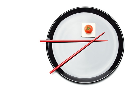Asian Food Composition. Chopsticks, cherry tomato and white tofu cheese on plateの写真素材