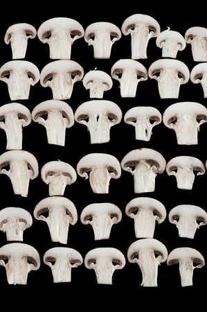 Macro detail background of sliced champignon mushrooms on blackの写真素材