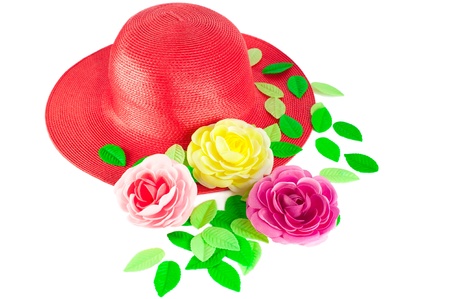 Red straw woman`s summer hat with roses isolated on white backgroundの写真素材