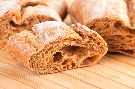 Fresh baguette on wooden table