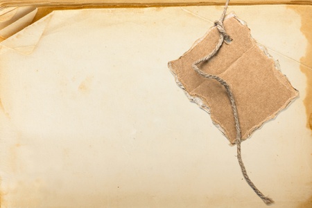 Old book page and cardboard blank on rope with space for your textの写真素材