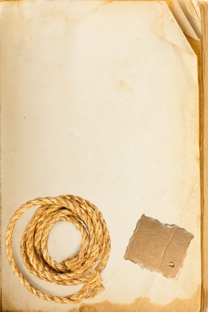 Old book page, hemp rope and cardboard blank with space for your textの写真素材