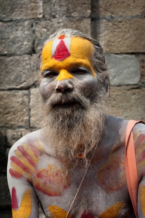 KATHMANDU, NEPAL, PASHUPATINATH TEMPLE - SEPTEMBER 21: Holy Sadhu man with traditional painted face, blessing in Pashupatinath Temple. Nepal, Kathmandu. September 21, 2012のeditorial素材