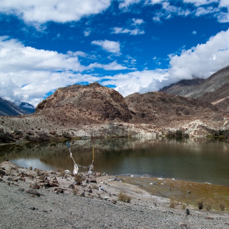 Highland landscape with hidden Buddhist Sacred Tso Yarab lake with buddhist praying flags. Himalaya. India, Ladakhの写真素材