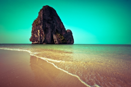 Tropical beach view  in vintage style. Ocean landscape with rock formation island at Pranang cave beach, Railay, Krabi, Thailandの写真素材