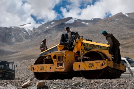 KHARDUNG LA PASS, INDIA - SEPTEMBER 12: Indian people working at road construction at Khardung La...