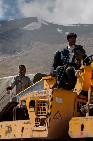 KHARDUNG LA PASS, INDIA - SEPTEMBER 12: Indian people working at road construction at Khardung La...