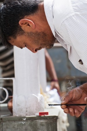LAHOUL VALLEY, INDIA - SEPTEMBER 06: Unidentified indian man burning essence sticks as religious offering on praying ceremony at Hindu Temple. India, Himachal Pradesh, Lahoul Valley September 06, 2012のeditorial素材