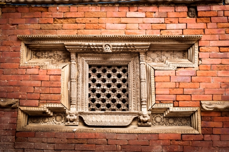 Hindu temple architecture detail. Carved wooden window on old Royal Palace. Nepal, Kathmandu, Durbar Square, Hanuman Dhokaの写真素材
