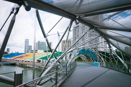 SINGAPORE - FEBRUARY 26: Urban landscape with Helix Bridge on February 26, 2013. Modern skyscrapers of business district Marina Bay Sands at most financial developing Asian city. Singaporeのeditorial素材