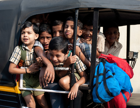 KOCHI, INDIA - FEBRUARY 25: Unidentified school children in uniform going home after classes at primary school by a rickshaw on February 25, 2013. India, Cochin (Kochi),  Keralaのeditorial素材