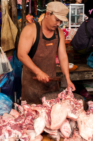 SIEM REAP, CAMBODIA - DEC 22, 2013: Unidentified Khmer woman selling meat at traditional food marketplace on Dec 22, 2013 in Siem Reap, Cambodia. Street food markets is popular tradition in asiaのeditorial素材