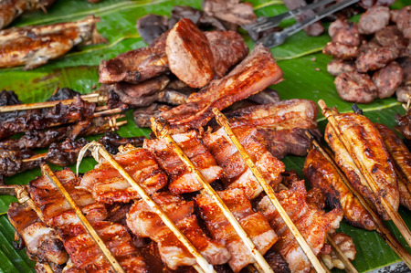 Traditional asian food at market. Delicious spicy grilled pork meatの写真素材