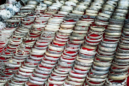 Lot of cheap souvenir bangles at asian market place. Laos