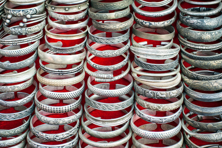 Lot of cheap souvenir bangles at asian market place. Laosの写真素材