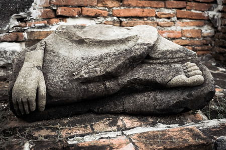 Asian religious art. Ancient sandstone sculpture of Buddha at Wat Mahathat ruins. Ayutthaya, Thailandの写真素材