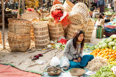 BAGAN, MYANMAR - JANUARY 16, 2014: Burmese people shopping spices, greengrocery and local goods at traditional asian marketplace. Burma travel destinationsのeditorial素材