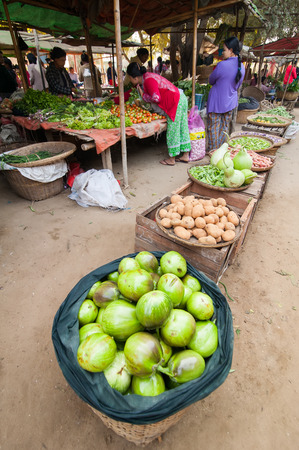 BAGAN, MYANMAR - JANUARY 16, 2014: Burmese people shopping spices, greengrocery and local goods at traditional asian marketplace. Burma travel destinationsのeditorial素材