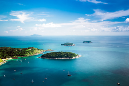 Tropical ocean landscape with Koh Kaeo island at turquoise ocean waives with boats near Ya Nui beach. Rawai, Phuket, Thailandの写真素材