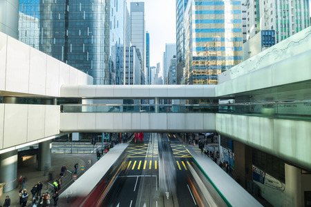 Abstract futuristic cityscape view with modern skyscrapers, bridge and walking people. Hong Kongのeditorial素材