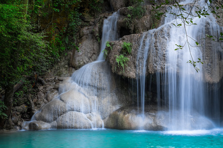 Jangle landscape with flowing turquoise water of Erawan cascade waterfall at deep tropical rain forest. National Park Kanchanaburi, Thailandの写真素材