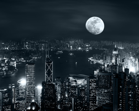 Night aerial view panorama of Hong Kong skyline at full moon night under cloudy skyの写真素材