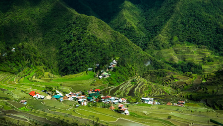 Village houses near rice terraces fields. Amazing abstract texture with sky colorful reflection in water. Ifugao province. Banaue, Philippines UNESCO heritageの写真素材