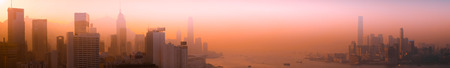 Hong Kong aerial cityscape panorama view. Skyline and Victoria Harbor at sunset. Asia travel...