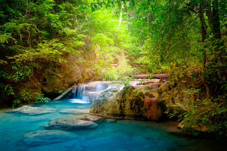 Jangle landscape with flowing turquoise water of Erawan cascade waterfall at deep tropical rain forest. National Park Kanchanaburi, Thailandの写真素材