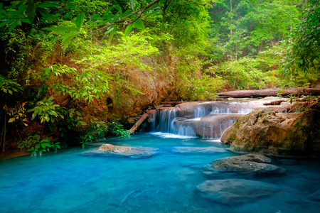 Jangle landscape with flowing turquoise water of Erawan cascade waterfall at deep tropical rain forest. National Park Kanchanaburi, Thailandの写真素材