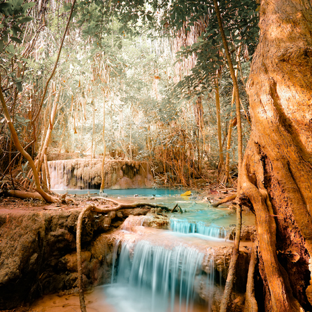 Fantasy jangle landscape with turquoise waterfall at deep tropical rain forest. Concept  for mysterious nature backgroundの写真素材