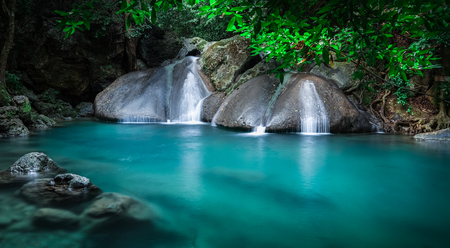 Jangle landscape with flowing turquoise water of Erawan cascade waterfall at deep tropical rain forest. National Park Kanchanaburi, Thailandの写真素材