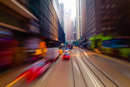 Moving through abstract modern city street with skyscrapers. Hong Kong. Abstract cityscape traffic background . Watercolor painting effect, motion blur, art toningの写真素材
