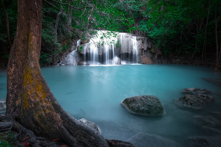 Jangle landscape with flowing turquoise water of Erawan cascade waterfall at deep tropical rain forest. National Park Kanchanaburi, Thailandの写真素材