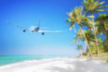 Blurred abstract background for travel concept. Airplane flying over amazing tropical beach with palm tree, white sand and turquoise ocean waves. Myanmar (Burma) travel destinationsの写真素材